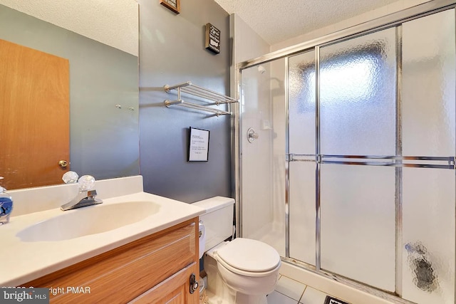 138 Banbury Dr, Bushkill, PA 18324 - full bath featuring toilet, vanity, a stall shower, a textured ceiling, and tile patterned flooring