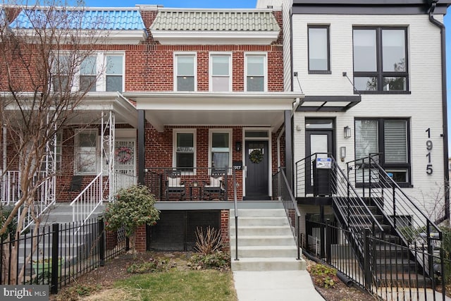 1917 H St NE, Washington, DC 20002 - multi unit property featuring brick siding, covered porch, a tiled roof, and stairs