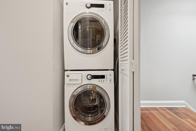 1917 H St NE, Washington, DC 20002 - washroom with estacked washer and dryer, baseboards, and wood finished floors
