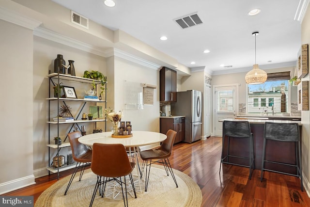 1917 H St NE, Washington, DC 20002 - dining area with dark wood-type flooring, ornamental molding, recessed lighting, and baseboards