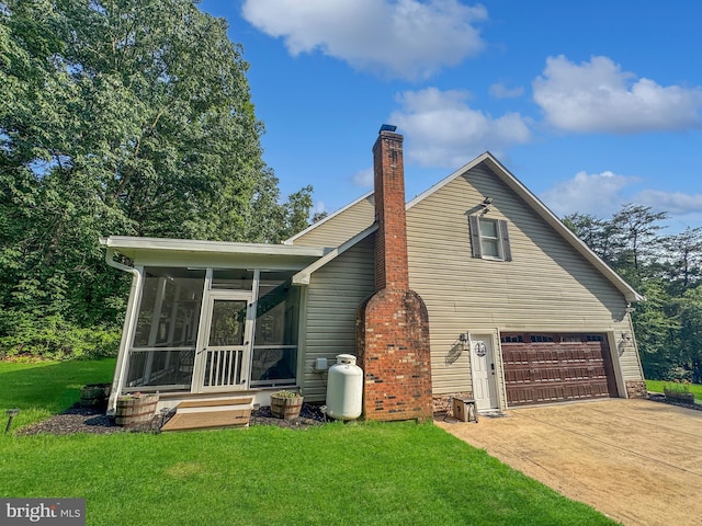14371 Bristow Rd, Manassas, VA 20112 - rear view of house featuring a sunroom, a lawn, an attached garage, and driveway
