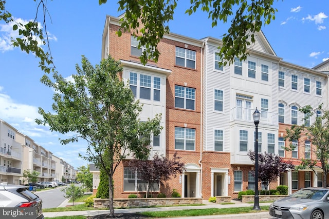 7444 Saint Margarets Blvd Unit A, Hanover, MD 21076 - view of property featuring brick siding and a residential view