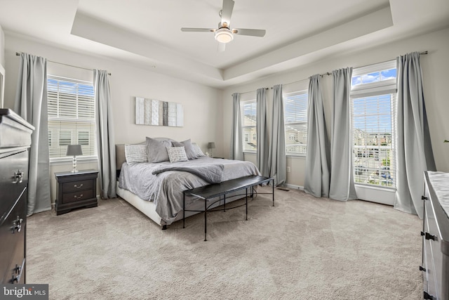7444 Saint Margarets Blvd Unit A, Hanover, MD 21076 - carpeted bedroom featuring a raised ceiling, multiple windows, and a ceiling fan