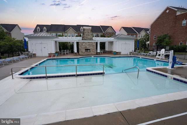 7444 Saint Margarets Blvd Unit A, Hanover, MD 21076 - pool at dusk featuring a pergola, a community pool, and a patio area