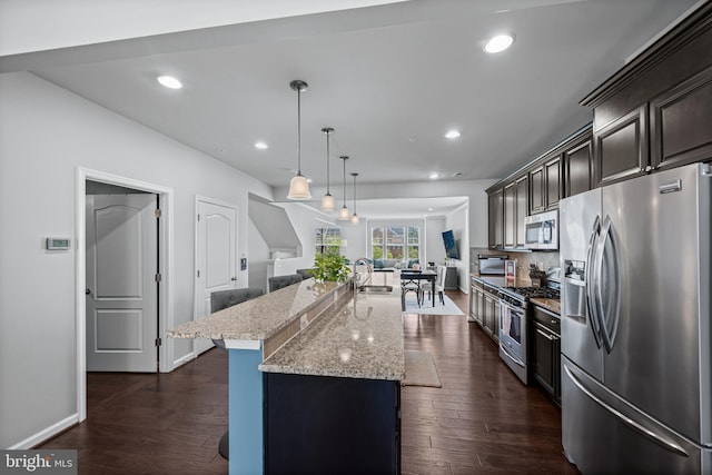 7444 Saint Margarets Blvd Unit A, Hanover, MD 21076 - kitchen with appliances with stainless steel finishes, a spacious island, light stone counters, decorative backsplash, and pendant lighting