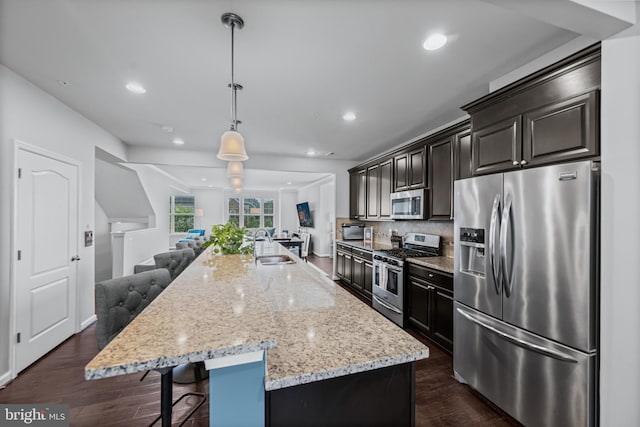 7444 Saint Margarets Blvd Unit A, Hanover, MD 21076 - kitchen with stainless steel appliances, open floor plan, light stone countertops, a breakfast bar, and a large island