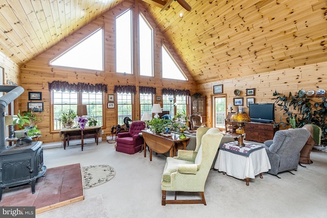 7600 Pohopoco Dr, Kunkletown, PA 18058 - living room with a wood stove, wooden walls, high vaulted ceiling, wooden ceiling, and carpet