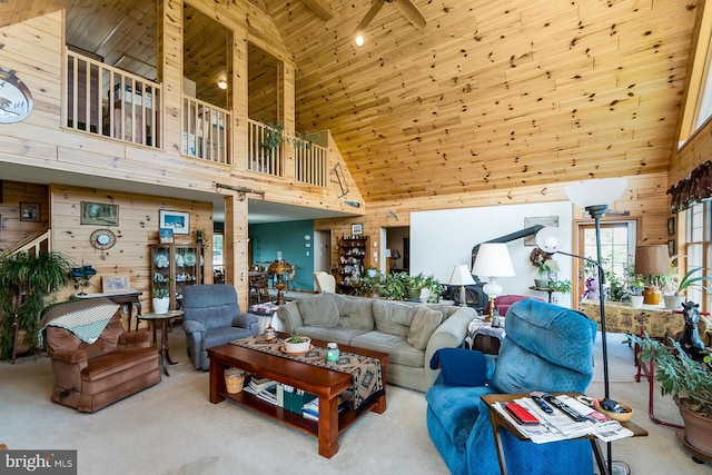 7600 Pohopoco Dr, Kunkletown, PA 18058 - living room with high vaulted ceiling, wooden walls, wooden ceiling, carpet, and ornate columns