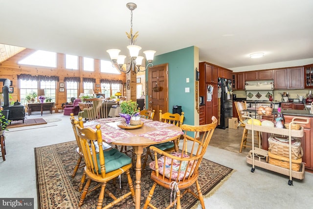 7600 Pohopoco Dr, Kunkletown, PA 18058 - dining space featuring a chandelier, light colored carpet, and a wood stove