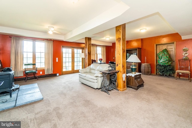 7600 Pohopoco Dr, Kunkletown, PA 18058 - living room featuring carpet flooring, a ceiling fan, a baseboard heating unit, and a wood stove
