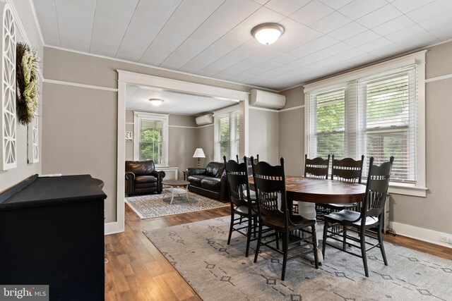 229 E Canal St, Hershey, PA 17033 - dining area featuring a wall unit AC, wood finished floors, ornamental molding, and a wall mounted air conditioner
