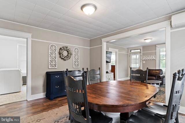 229 E Canal St, Hershey, PA 17033 - dining area with a wall unit AC and dark wood finished floors