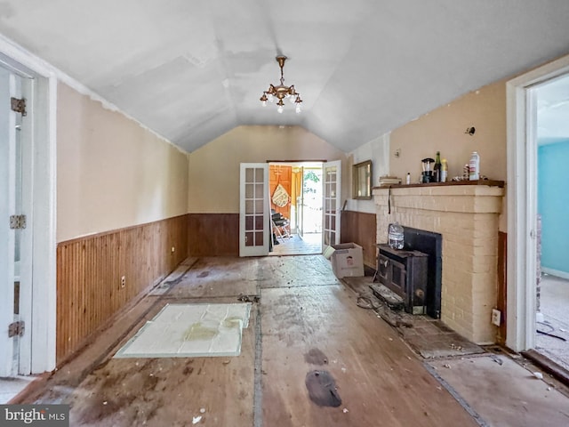 4725 Idlewilde Rd, Shady Side, MD 20764 - unfurnished living room featuring a wainscoted wall, wooden walls, vaulted ceiling, and a wood stove