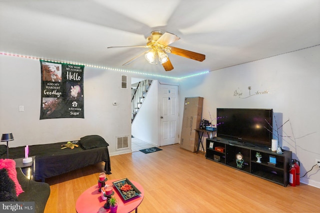 3109 Bero Rd, Halethorpe, MD 21227 - living room featuring wood finished floors, stairway, and a ceiling fan