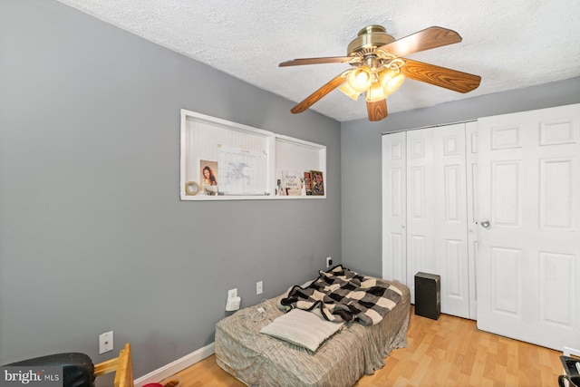 3109 Bero Rd, Halethorpe, MD 21227 - bedroom with light wood-type flooring, a closet, a textured ceiling, and ceiling fan