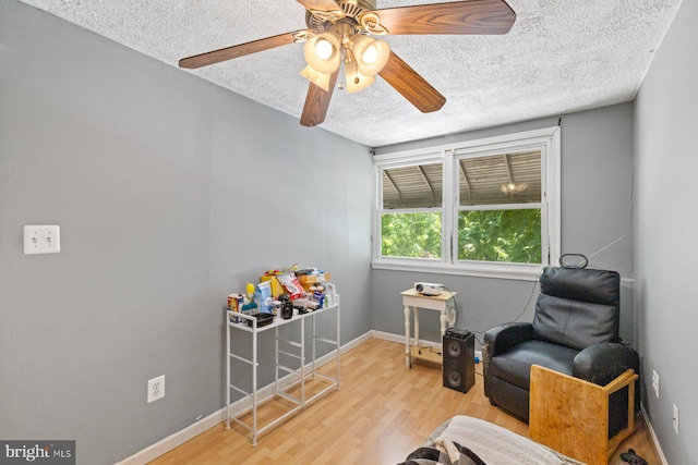 3109 Bero Rd, Halethorpe, MD 21227 - sitting room with a textured ceiling, wood finished floors, and ceiling fan