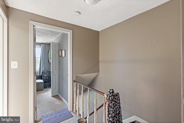 3109 Bero Rd, Halethorpe, MD 21227 - hall featuring an upstairs landing, a textured ceiling, and carpet flooring