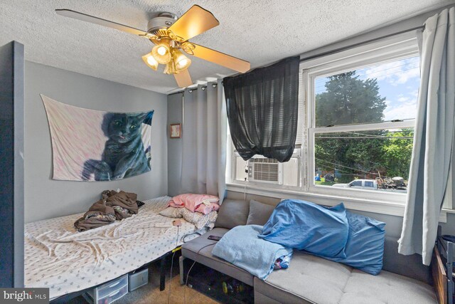 3109 Bero Rd, Halethorpe, MD 21227 - bedroom featuring a textured ceiling, a ceiling fan, and cooling unit