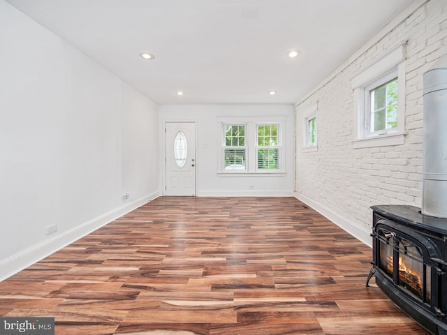 408 Summit Ave, Fort Washington, PA 19034 - foyer entrance featuring a wood stove, wood finished floors, recessed lighting, and brick wall