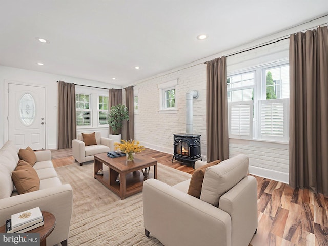 408 Summit Ave, Fort Washington, PA 19034 - living room with brick wall, a wood stove, light wood-style floors, and recessed lighting