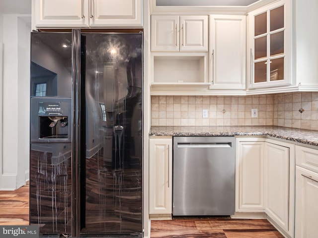 408 Summit Ave, Fort Washington, PA 19034 - kitchen featuring black fridge with ice dispenser, stainless steel dishwasher, light stone counters, and tasteful backsplash
