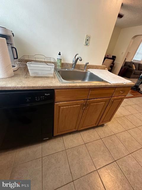 710 Wildell Rd Unit 108, Drexel Hill, PA 19026 - kitchen with dishwasher, light tile patterned floors, light countertops, a textured ceiling, and arched walkways