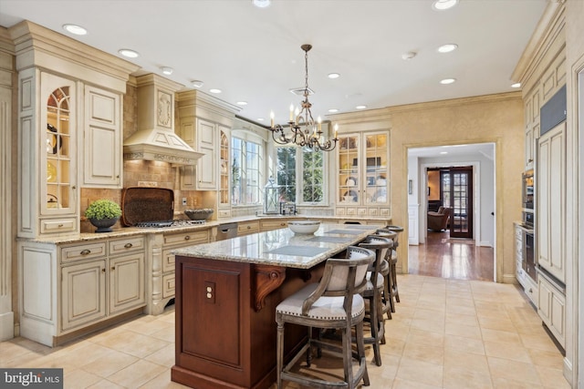 845 Colony Ct, Bryn Mawr, PA 19010 - kitchen featuring cream cabinetry, a chandelier, glass insert cabinets, recessed lighting, and decorative backsplash