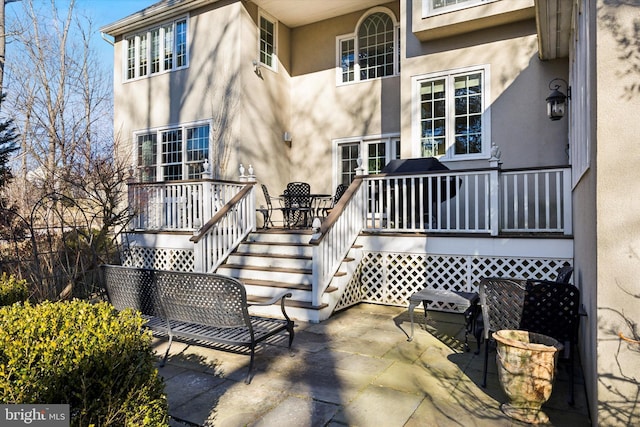 845 Colony Ct, Bryn Mawr, PA 19010 - entrance to property with stucco siding, a patio, and a wooden deck
