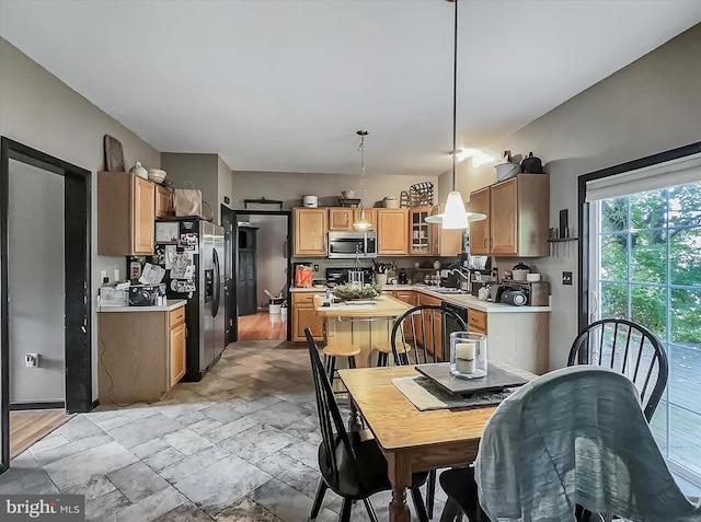 25 Domenick Dr, York, PA 17402 - kitchen featuring appliances with stainless steel finishes, light countertops, pendant lighting, a kitchen island, and glass insert cabinets