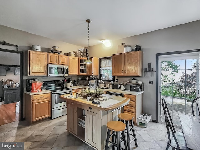 25 Domenick Dr, York, PA 17402 - kitchen featuring stainless steel appliances, a kitchen island, glass insert cabinets, hanging light fixtures, and wooden counters
