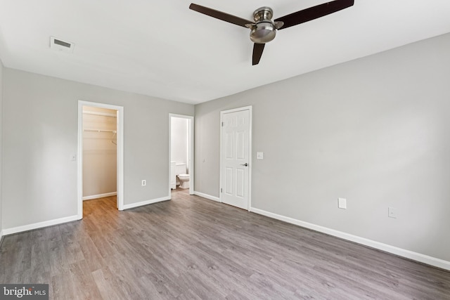18330 Streamside Dr Unit 303, Gaithersburg, MD 20879 - unfurnished bedroom with wood finished floors, a spacious closet, a closet, a ceiling fan, and ensuite bathroom