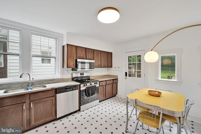 1622 Delaware Ave, Wyomissing, PA 19610 - kitchen with appliances with stainless steel finishes, light countertops, light flooring, and decorative light fixtures