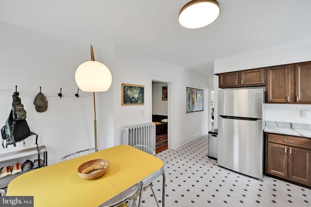 1622 Delaware Ave, Wyomissing, PA 19610 - kitchen with freestanding refrigerator, radiator, light flooring, and dark brown cabinets