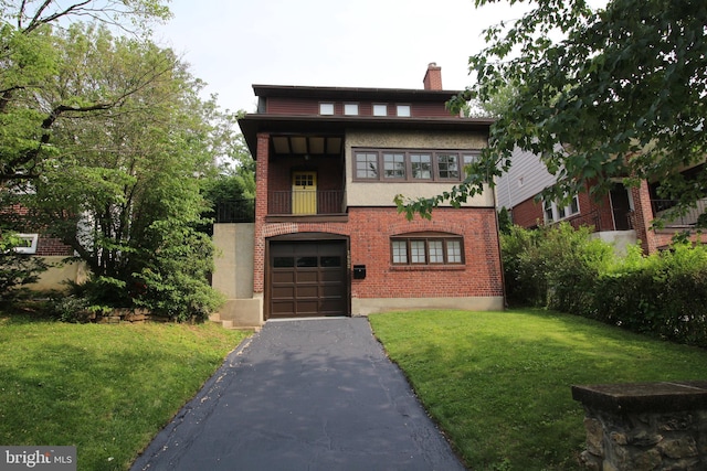 1622 Delaware Ave, Wyomissing, PA 19610 - view of front of home featuring asphalt driveway, a balcony, a chimney, a front lawn, and a garage