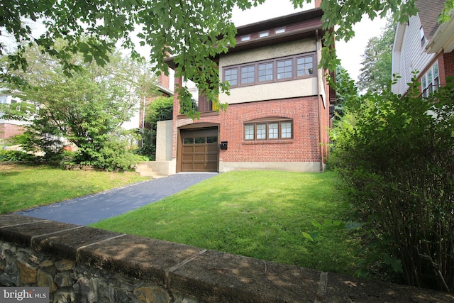 1622 Delaware Ave, Wyomissing, PA 19610 - view of front facade featuring asphalt driveway, an attached garage, a front lawn, and brick siding
