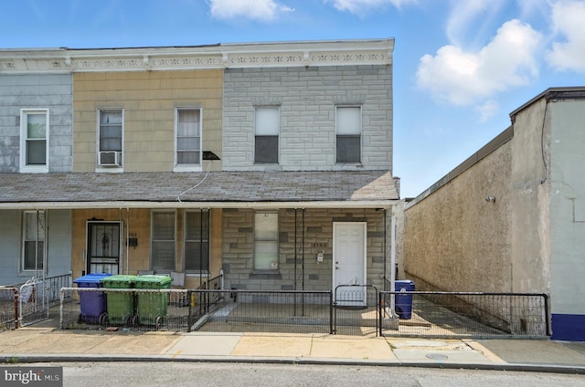 2105 Maisel St, Baltimore, MD 21230 - view of property featuring covered porch, a fenced front yard, and stone siding