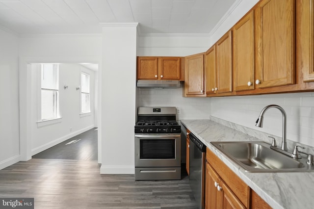 2105 Maisel St, Baltimore, MD 21230 - kitchen with under cabinet range hood, appliances with stainless steel finishes, crown molding, backsplash, and brown cabinetry
