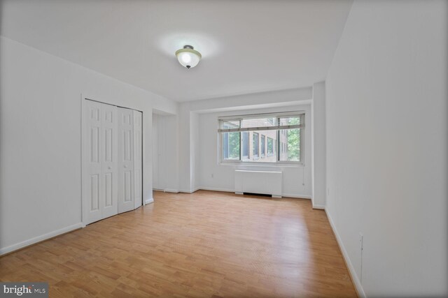 4201 Cathedral Ave NW Unit 303E, Washington, DC 20016 - unfurnished bedroom featuring radiator and light wood finished floors