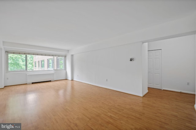 4201 Cathedral Ave NW Unit 303E, Washington, DC 20016 - unfurnished room with radiator and light wood-style floors