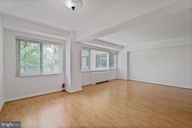 4201 Cathedral Ave NW Unit 303E, Washington, DC 20016 - empty room featuring plenty of natural light, wood finished floors, and radiator
