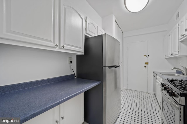 4201 Cathedral Ave NW Unit 303E, Washington, DC 20016 - kitchen featuring stainless steel appliances, white cabinetry, and dark countertops