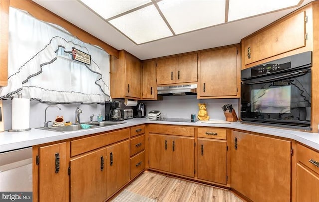3324 Golf Course Rd, Allentown, PA 18104 - kitchen featuring black appliances, under cabinet range hood, light countertops, light wood-style floors, and brown cabinetry