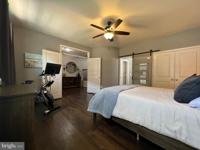 13755 Tides St, Woodbridge, VA 22191 - bedroom with dark wood finished floors, a barn door, a ceiling fan, and a closet