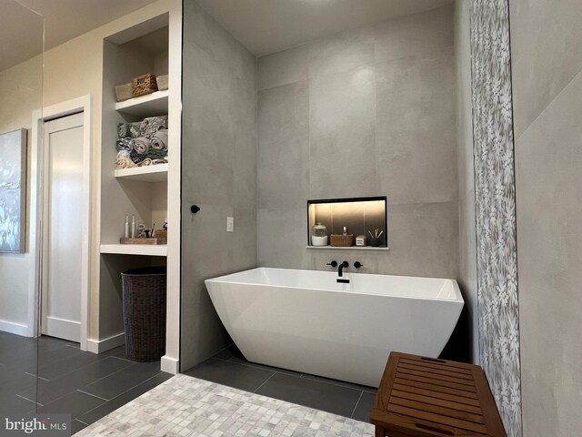 13755 Tides St, Woodbridge, VA 22191 - bathroom with tile patterned floors and a freestanding tub