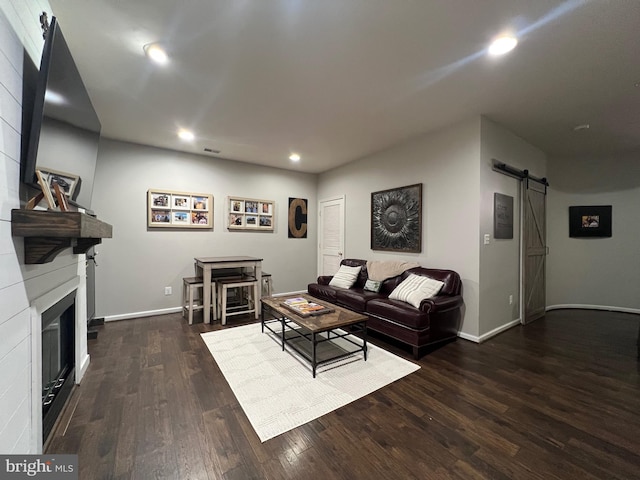 13755 Tides St, Woodbridge, VA 22191 - living area featuring a barn door, recessed lighting, wood finished floors, and a glass covered fireplace