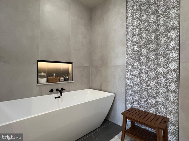13755 Tides St, Woodbridge, VA 22191 - full bathroom featuring a freestanding tub, tile walls, and tile patterned floors