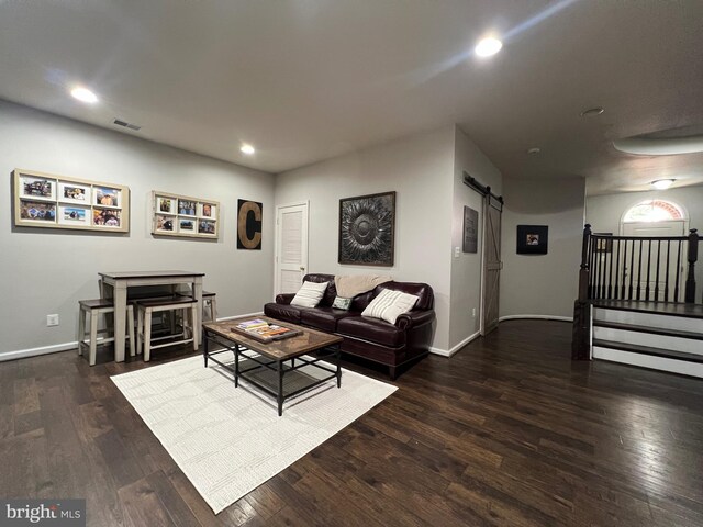 13755 Tides St, Woodbridge, VA 22191 - living area featuring a barn door, wood finished floors, recessed lighting, and stairs