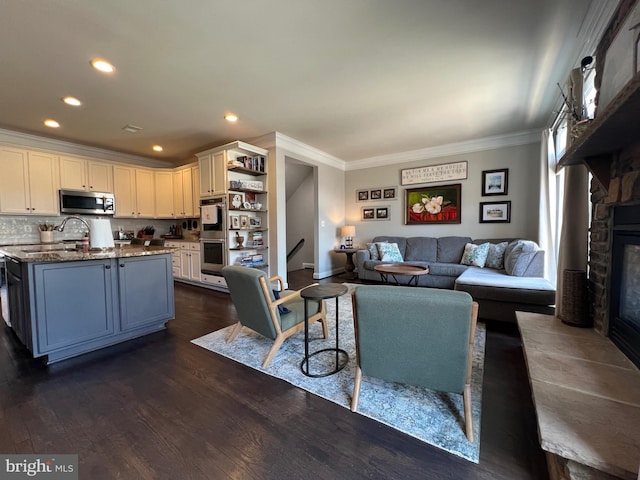 13755 Tides St, Woodbridge, VA 22191 - living room featuring crown molding, a fireplace, dark wood-style flooring, and recessed lighting