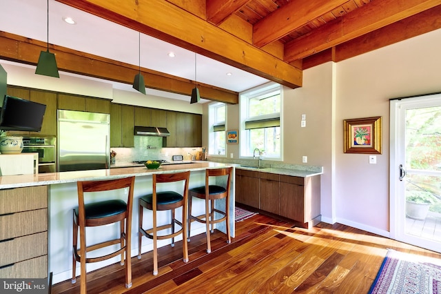 4305 Blagden Ave NW, Washington, DC 20011 - kitchen featuring built in refrigerator, under cabinet range hood, dark wood-style flooring, decorative backsplash, and beamed ceiling