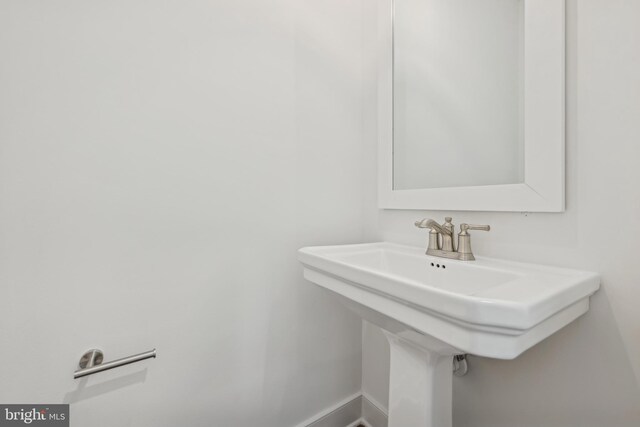 19704 Crows Nest Ct, Georgetown, DE 19947 - bathroom with a sink and baseboards